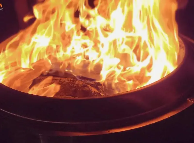 Image of a blazing smokeless fire pit at night