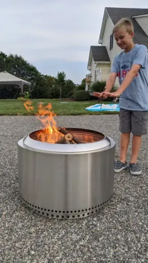 Image of a Backyard Toasty kid with a Solo Stove Yukon